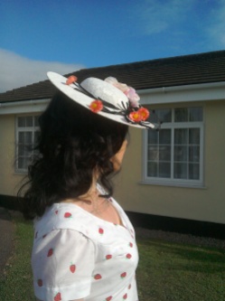 Cream lace tilt hat with flowers and black net